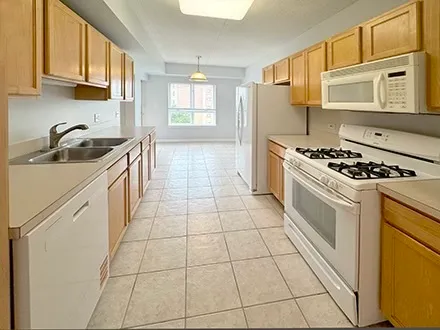 a kitchen with a stove a sink dishwasher and a microwave