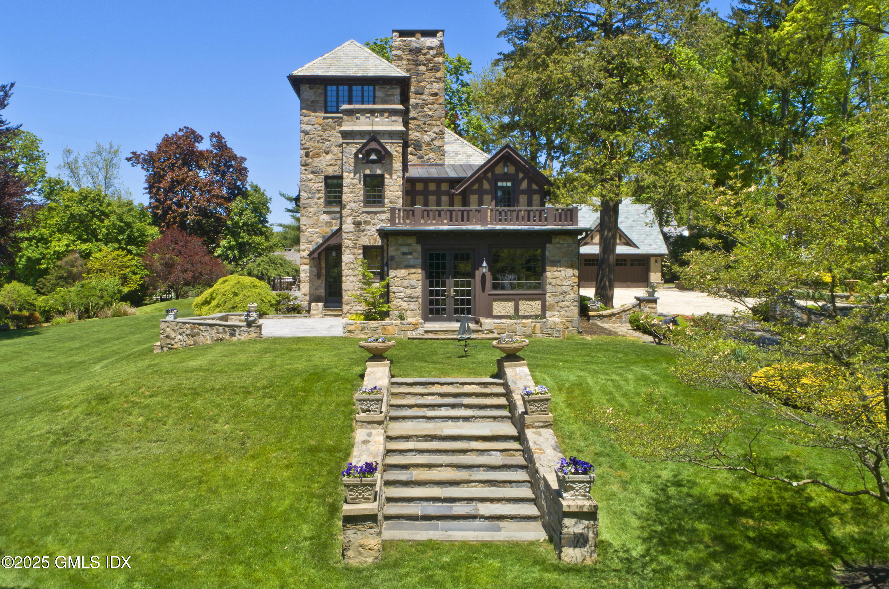 47 Carriglea Drive Riverside, CT 06878 - Photo 22 of 26 a front view of a house with a yard table and chairs