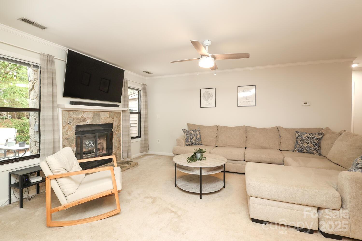 500 Sweetgum Drive, Unit 48C Fort Mill, SC 29715 - Photo 12 of 40 a living room with furniture a flat screen tv and a fireplace