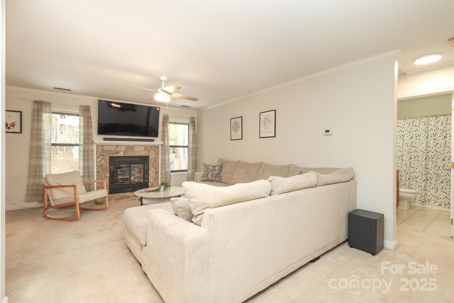 500 Sweetgum Drive, Unit 48C Fort Mill, SC 29715 - Photo 13 of 40 a living room with furniture a flat screen tv and a fireplace