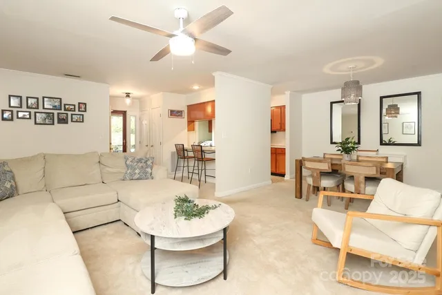 a living room with furniture and a dining table