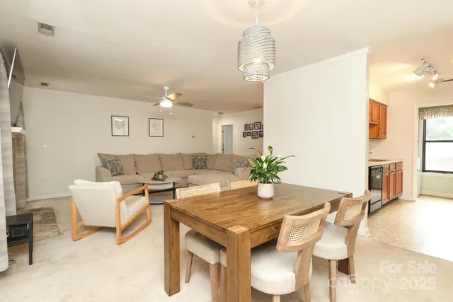 a living room with dining table and chairs