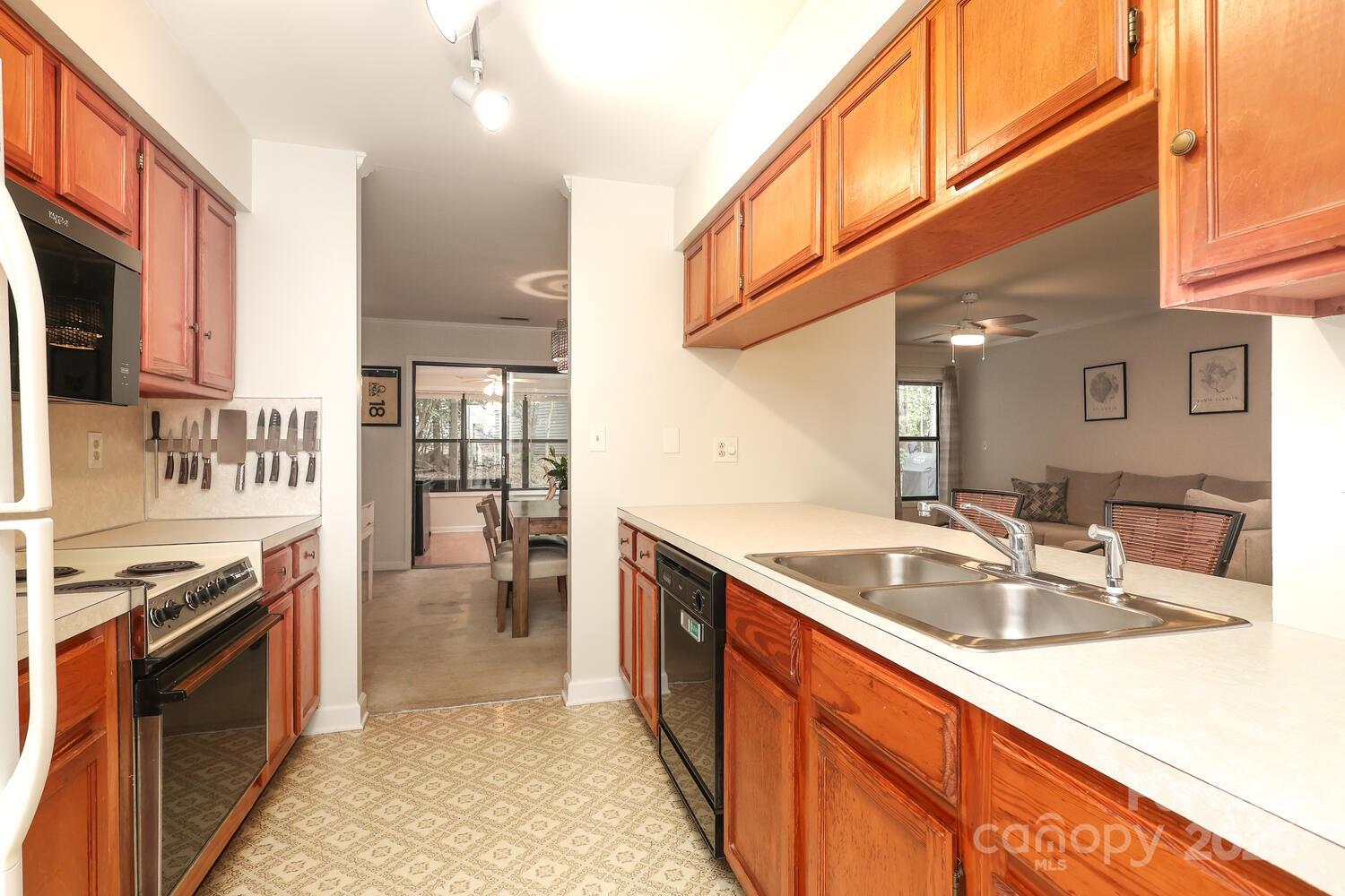500 Sweetgum Drive, Unit 48C Fort Mill, SC 29715 - Photo 23 of 40 a kitchen with stainless steel appliances granite countertop a sink stove and refrigerator