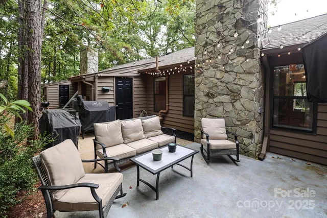 a backyard of a house with table and chairs
