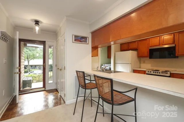 a view of a kitchen with a dining table and chairs