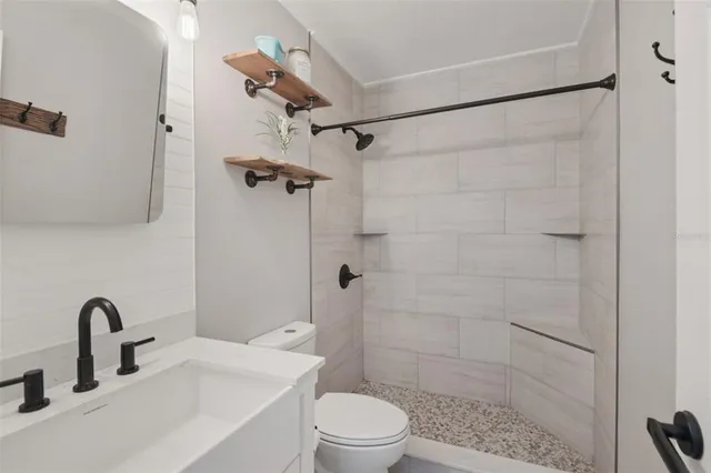 a bathroom with a sink toilet and shower