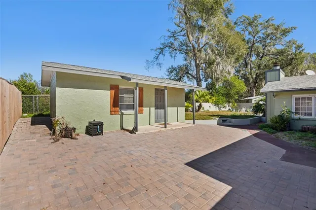 a view of a house with backyard and sitting area