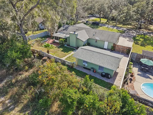 an aerial view of a house with outdoor space
