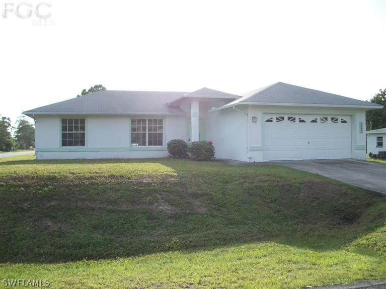 11 Kansas Road Lehigh Acres, FL 33936 - Photo 1 of 12 a house view with a garden space