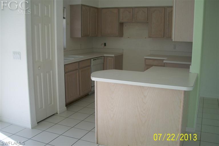 11 Kansas Road Lehigh Acres, FL 33936 - Photo 3 of 12 a utility room with dryer and washer