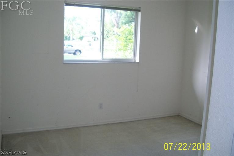 11 Kansas Road Lehigh Acres, FL 33936 - Photo 9 of 12 an empty room with a window