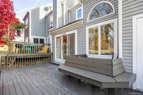 a view of house with deck and wooden floor