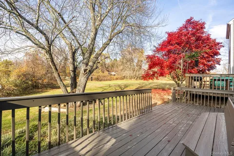 a balcony with wooden floor and trees