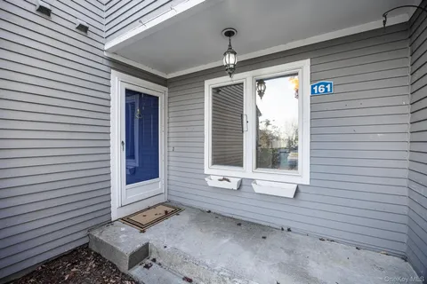 a view of a porch with a door and a window