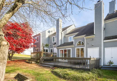 a front view of a house with a yard glass top table and chairs