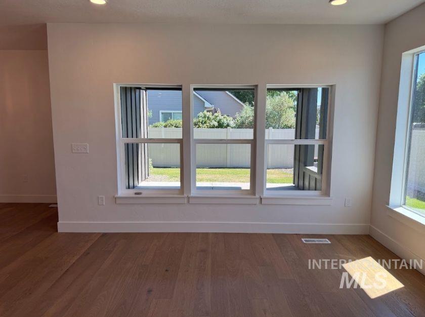 755 West Wrangler Street Meridian, ID 83646 - Photo 7 of 35 Spacious interior featuring wood-finish flooring, recessed lighting, and crisp white walls with matching baseboards