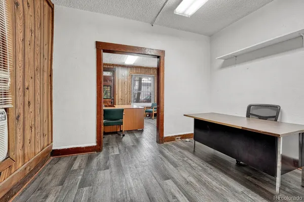 a room with wooden floor and furniture