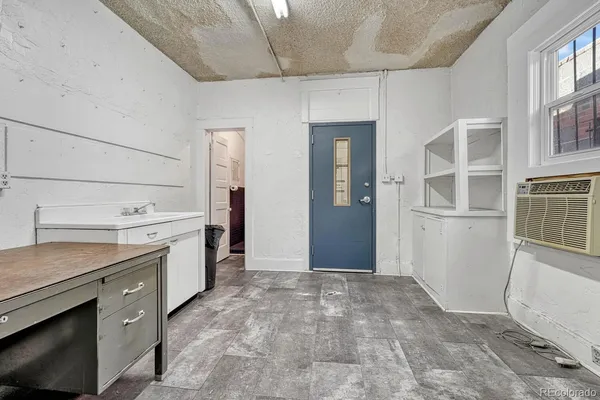 a view of a kitchen with furniture and an empty room
