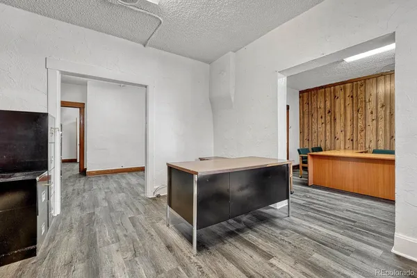 a view of kitchen with wooden floor and electronic appliances