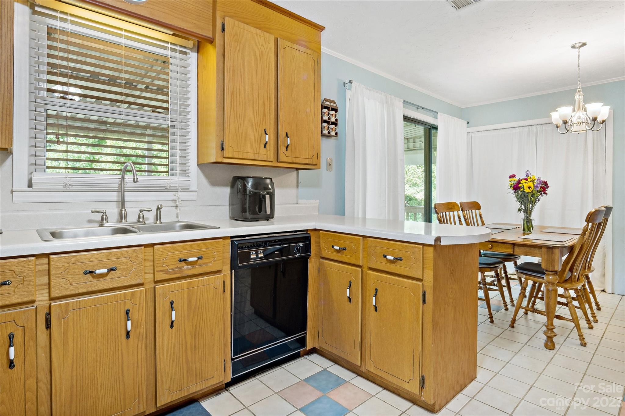 5232 Bat Cave Road Old Fort, NC 28762 - Photo 17 of 32 a kitchen with stainless steel appliances granite countertop a sink dishwasher and cabinets with wooden floor