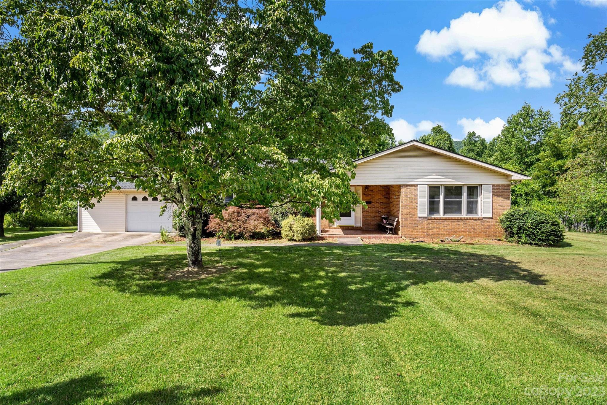 5232 Bat Cave Road Old Fort, NC 28762 - Photo 2 of 32 a backyard of a house with table and chairs