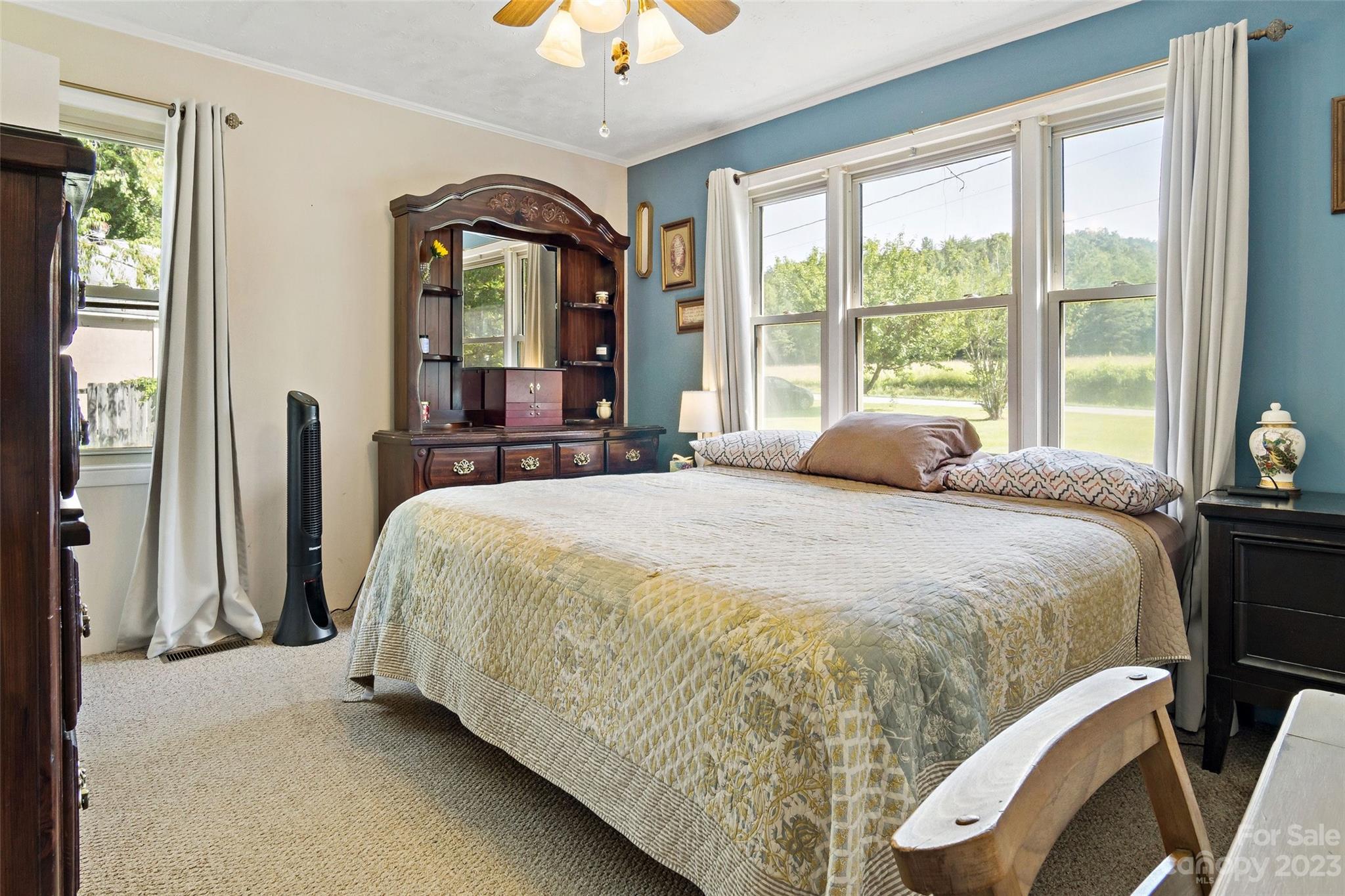 5232 Bat Cave Road Old Fort, NC 28762 - Photo 27 of 32 a bed sitting in a bedroom next to a window