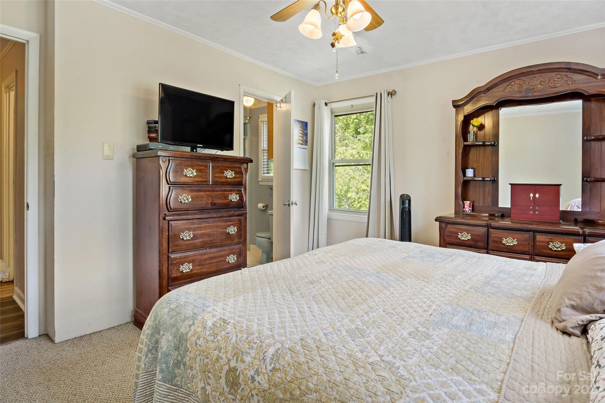 5232 Bat Cave Road Old Fort, NC 28762 - Photo 29 of 32 a bedroom with a bed and a flat screen tv