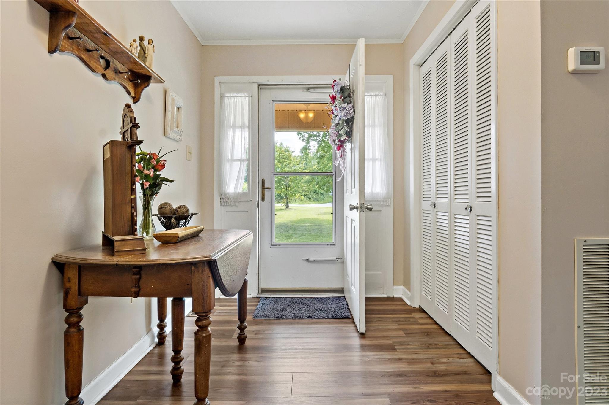 5232 Bat Cave Road Old Fort, NC 28762 - Photo 6 of 32 a view of a hallway with wooden floor and windows