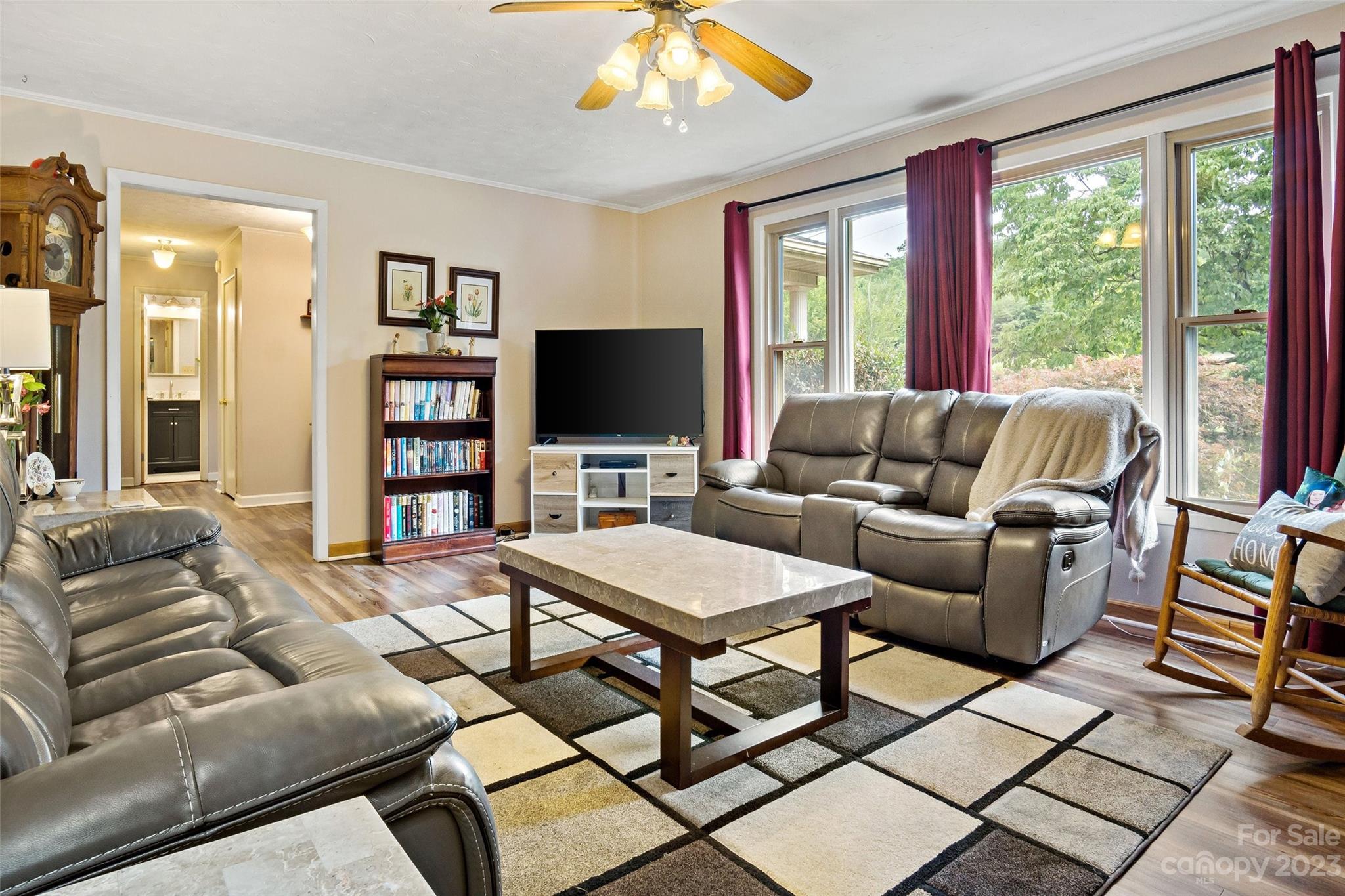 5232 Bat Cave Road Old Fort, NC 28762 - Photo 9 of 32 a living room with furniture a flat screen tv and a large window