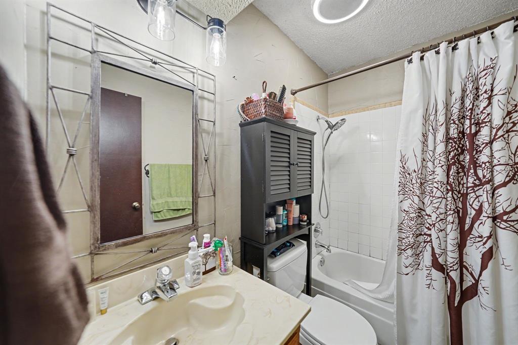 7624 Maple Hill Road Watauga, TX 76148 - Photo 11 of 20 Vanity with integrated sink, chrome faucet, and decorative mirror