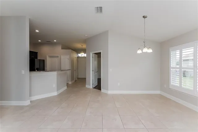 a view of a kitchen with a refrigerator and window