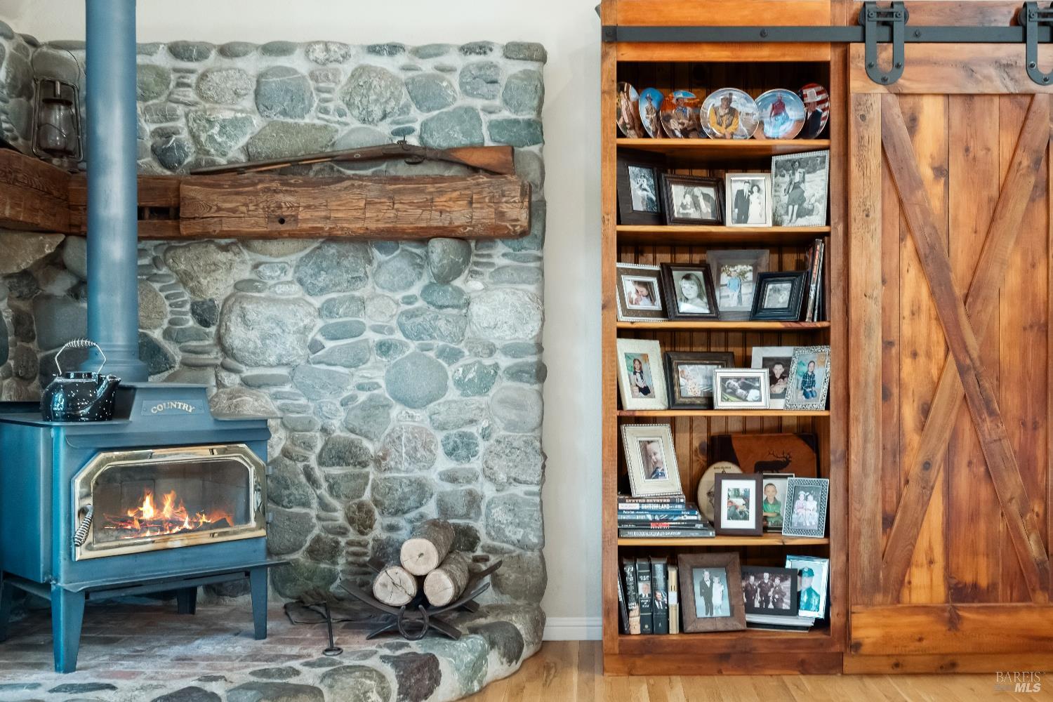 5701 Ridgewood Road Willits, CA 95490 - Photo 29 of 84 a living room with lots of books and a fireplace