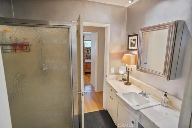 a en suite bathroom with a double vanity sink a mirror and a shower