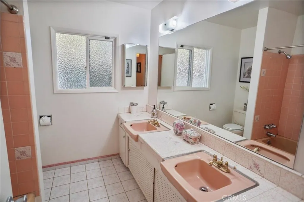 8636 Delco Avenue Winnetka, CA 91306 - Photo 15 of 20 a bathroom with a sink vanity and mirror