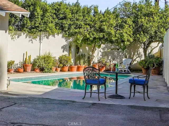 a backyard of a house with table and chairs