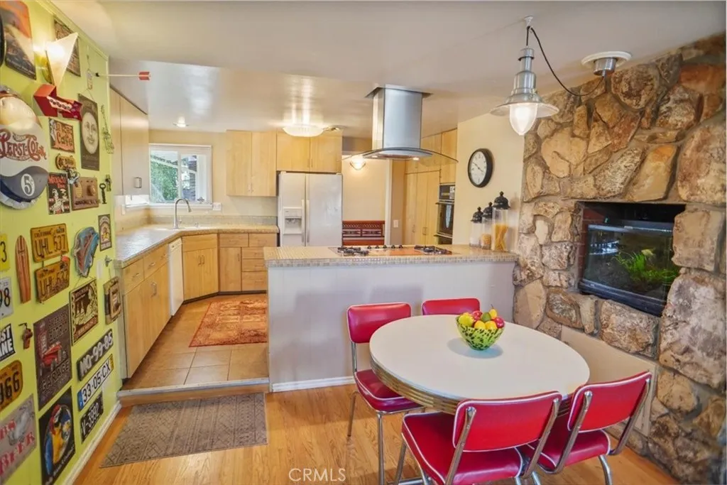 8636 Delco Avenue Winnetka, CA 91306 - Photo 7 of 20 a living room with stainless steel appliances furniture a rug and a kitchen