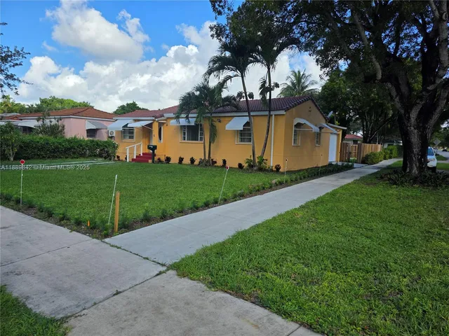 a front view of a house with garden