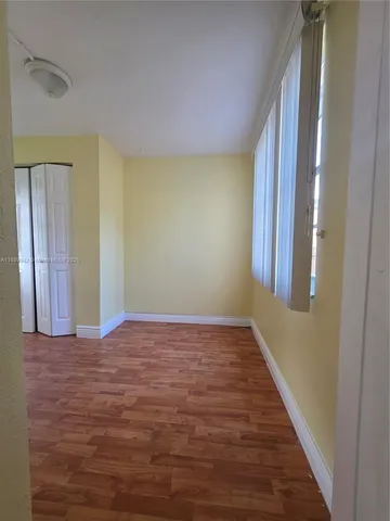 a view of an empty room and wooden floor