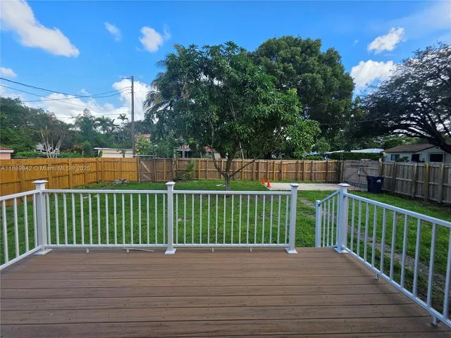 a view of a balcony and yard
