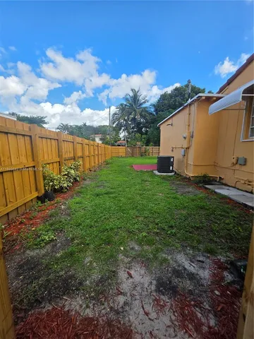 a view of a backyard with sitting area