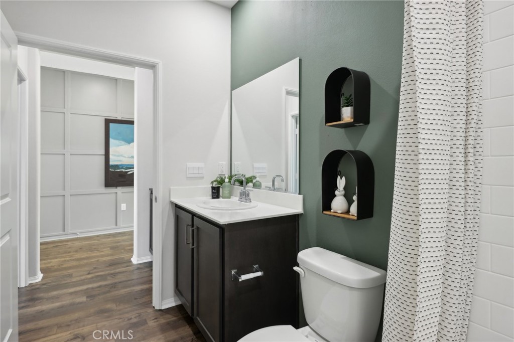 83241 Thrush Way Indio, CA 92201 - Photo 18 of 33 a bathroom with a toilet sink and mirror