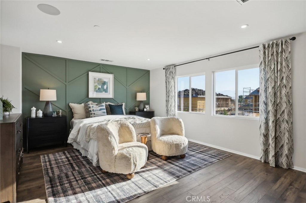83241 Thrush Way Indio, CA 92201 - Photo 23 of 33 a spacious bedroom with a bed and wooden floor