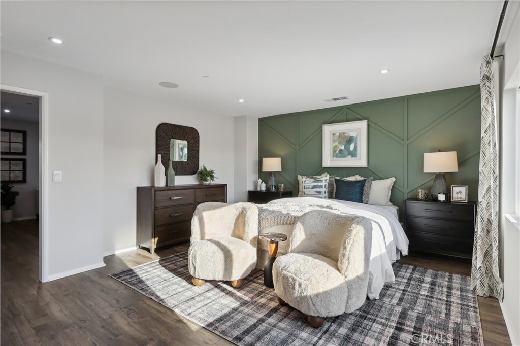 83241 Thrush Way Indio, CA 92201 - Photo 26 of 33 a spacious bedroom with a bed and wooden floor