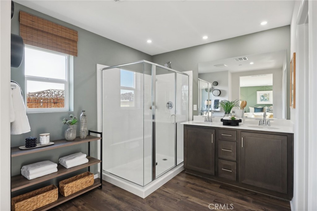 83241 Thrush Way Indio, CA 92201 - Photo 27 of 33 a spacious bathroom with a double vanity sink a mirror and a shower