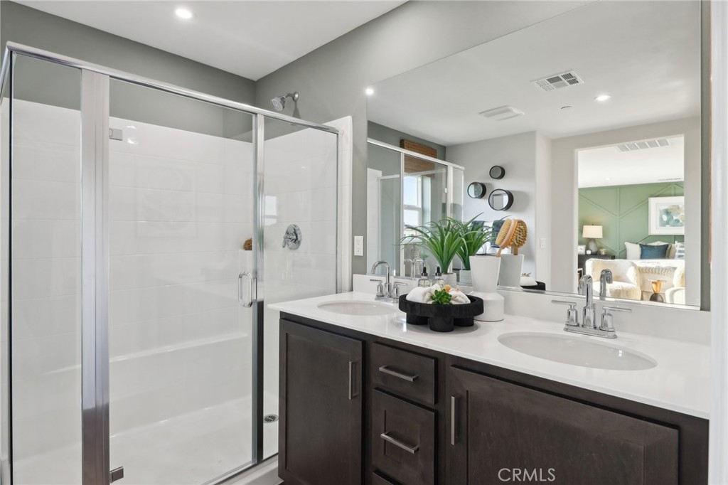 83241 Thrush Way Indio, CA 92201 - Photo 28 of 33 a bathroom with a double vanity sink mirror and shower
