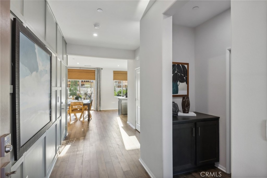 83241 Thrush Way Indio, CA 92201 - Photo 2 of 33 a view of a hallway to a livingroom with wooden floor and furniture