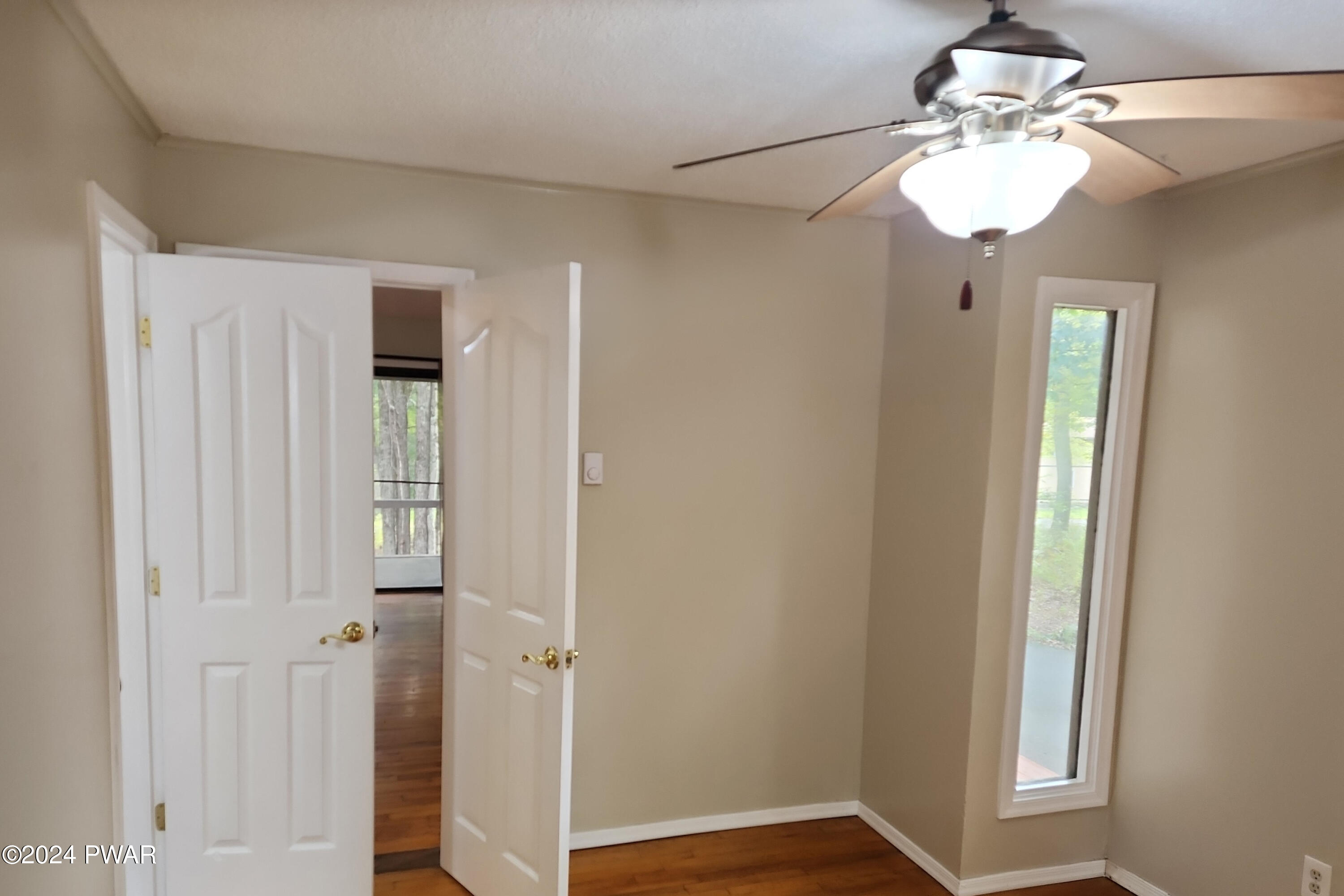 107 Rodeo Lane Hawley, PA 18428 - Photo 18 of 29 a view of a hallway with a window and chandelier fan