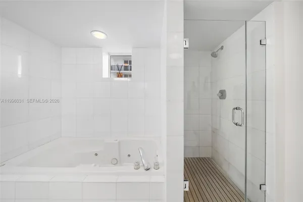 a bathroom with a bathtub and a shower
