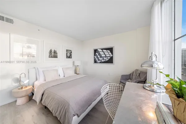 a bedroom with a bed and a table