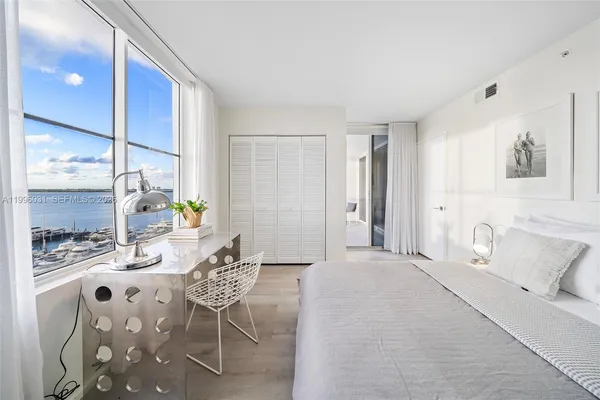a bedroom with furniture and a window